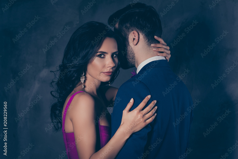 Portrait of beautiful pretty charming woman with curls looking at camera touching mysterious man with bristle in tux isolated on grey background, feminism adultery posh evening concept - obrazy, fototapety, plakaty 