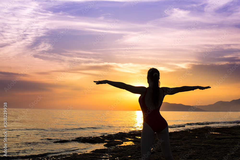 silhouette of woman on the sunset. yoga practice.
