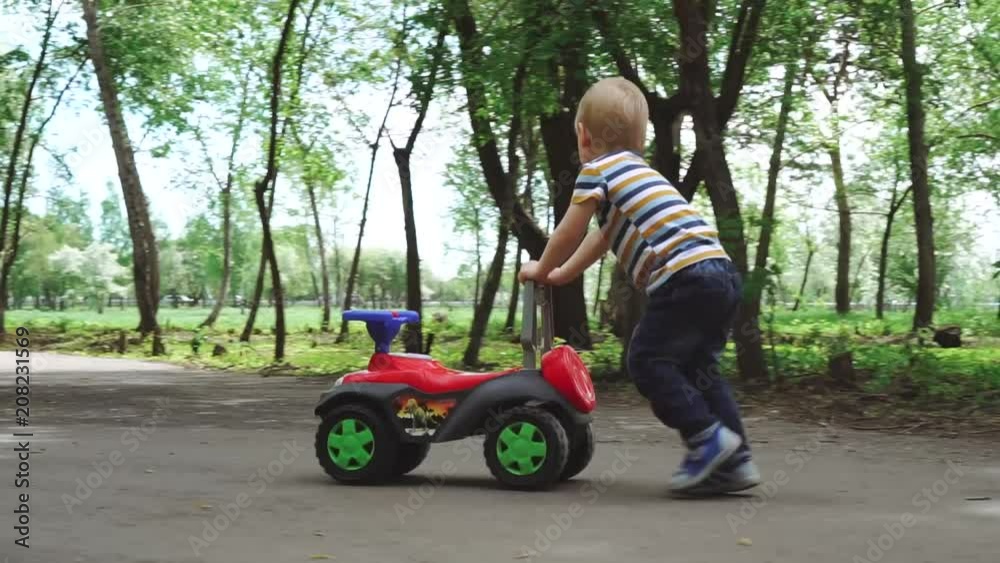 A little boy is pushing his toy car A little boy is pushing his toy car