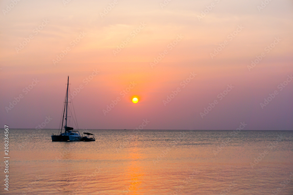 Sunset with silhouette of boat in Kendwa, Zanzibar island, Tanzania Africa
