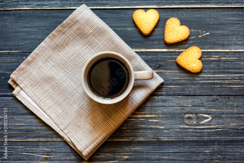 coffee on a wooden table with cookies hearts