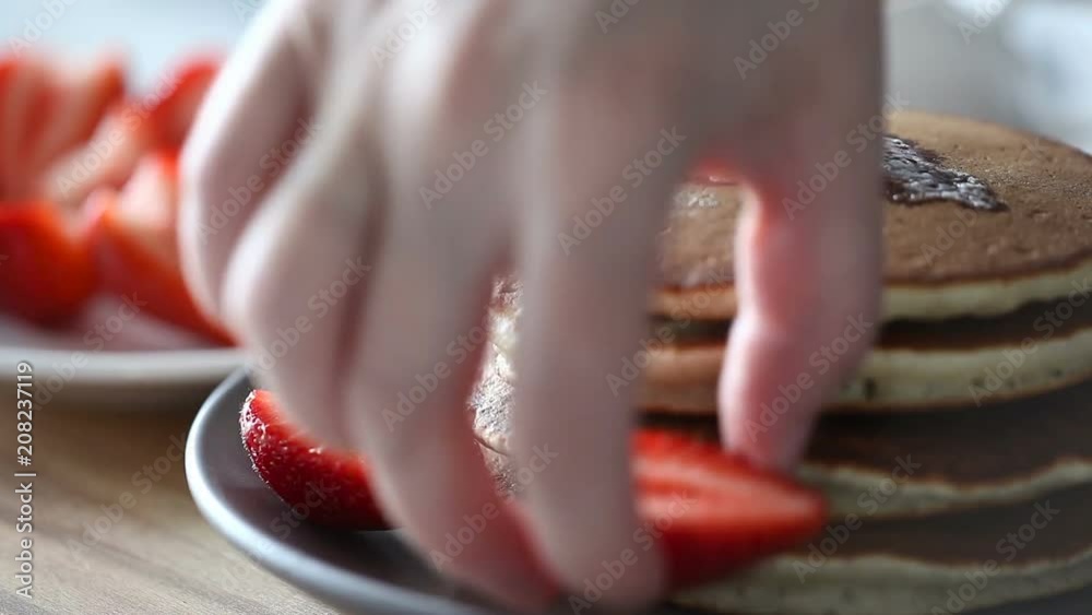 Close-up. A female hands takes strawberry. Healthy breakfast. Close-up. A female hands takes strawberry. Healthy breakfast.