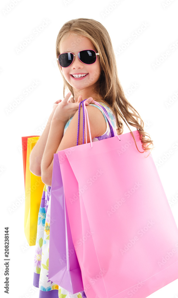 Adorable little girl child in sunglasses holding shopping colorful paper bags isolated Adorable little girl child in sunglasses holding shopping colorful paper bags isolated