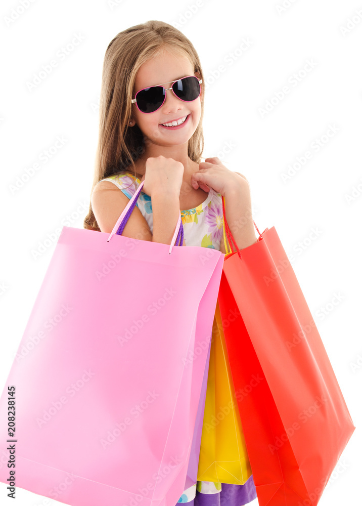 Adorable little girl child in sunglasses holding shopping colorful paper bags isolated Adorable little girl child in sunglasses holding shopping colorful paper bags isolated