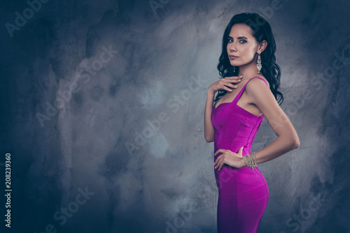 Portrait with copy space empty place of pretty stunning woman in cocktail dress holding hand on waist looking at camera isolated on grey background, advertisement concept