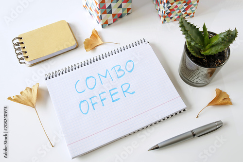 combo offer written in a notebook on white table photo