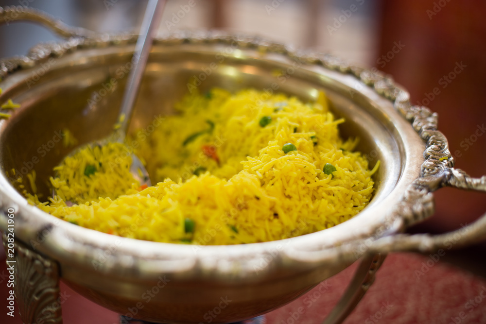 Indian curry rice in a beautiful brass bowl at a street food festival Indian curry rice in a beautiful brass bowl at a street food festival