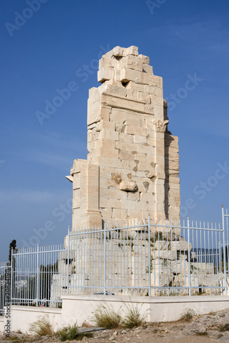 Greece, Athens: Philopappu Monument on top of the hill opposite the famous Acropolis in the city center of the Greek capital with fence and blue sky in the background - concept travel history culture photo