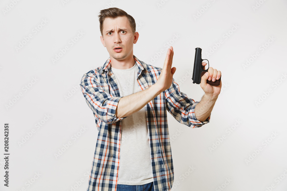 Man with gun in hand showing stop gesture with palm isolated on white background. Male hand no shooting symbol. Stop violence, weapons in school control, no killing people children, problem concept. Man with gun in hand showing stop gesture with palm isolated on white background. Male hand no shooting symbol. Stop violence, weapons in school control, no killing people children, problem concept.