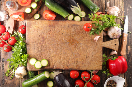 wooden board with raw vegetables