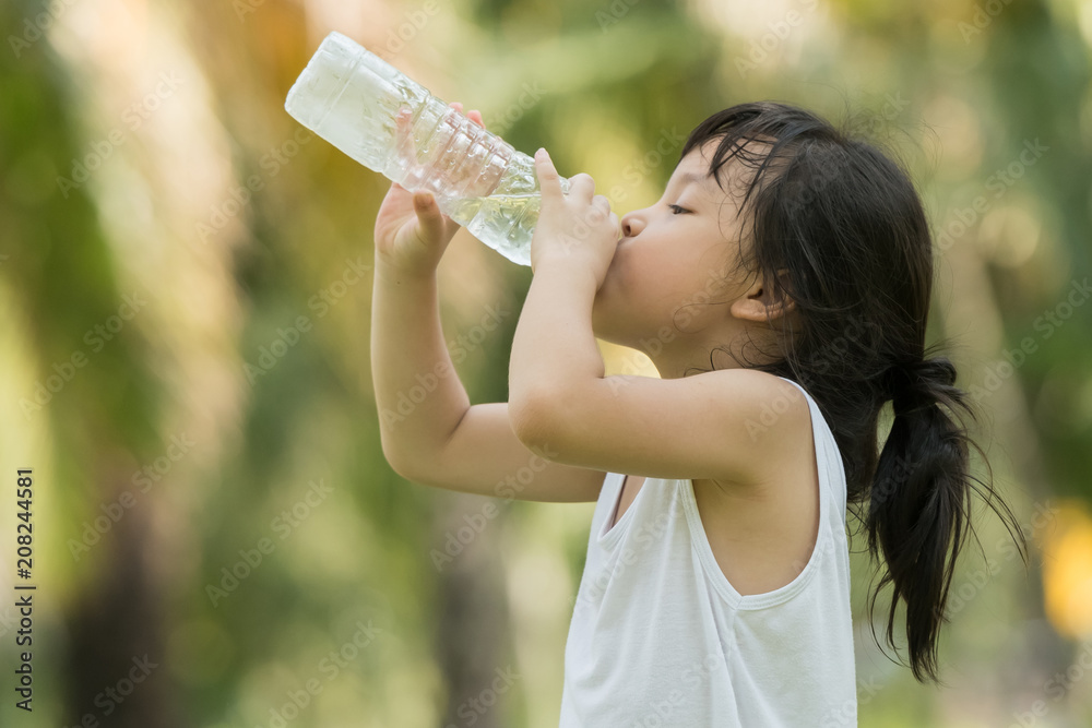 Child drinking pure water in nature Child drinking pure water in nature
