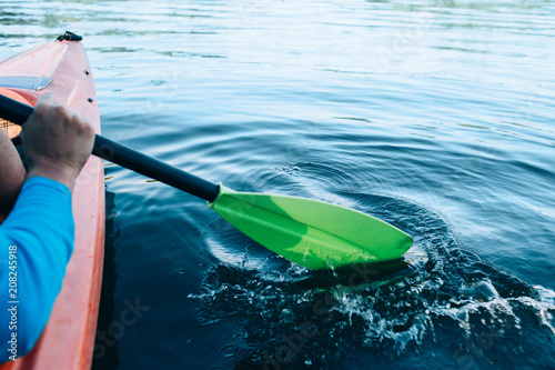 Canvastavla kayaker paddles across a serene lake