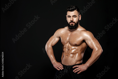 strong bodybuilder posing in studio