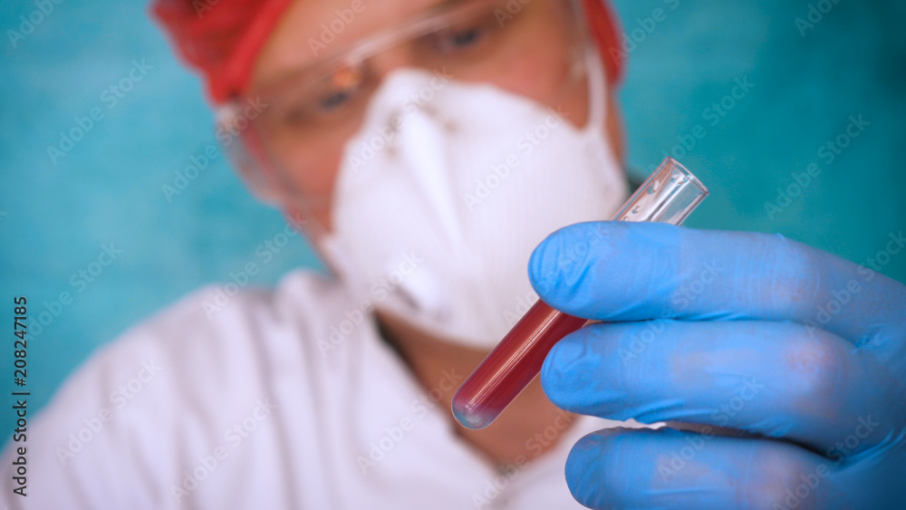 The alchemist, a biologist, takes the DNA of various substances, in a respirator, in a protective cap, in goggles, in a white medical gown, a flask, a green background, a science table. The alchemist, a biologist, takes the DNA of various substances, in a respirator, in a protective cap, in goggles, in a white medical gown, a flask, a green background, a science table.
