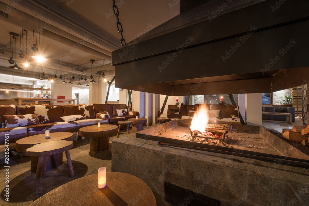 Fire in fireplace and setting tables in restaurant Fire in fireplace and setting tables in restaurant