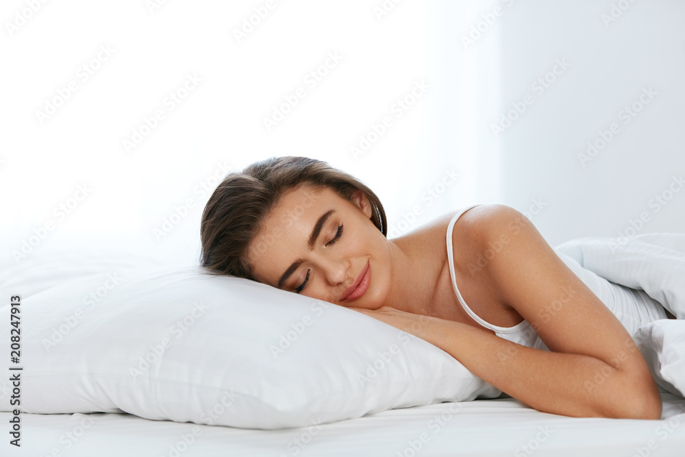 White Bedding. Woman Sleeping On Mattress With Pillow. White Bedding. Woman Sleeping On Mattress With Pillow.