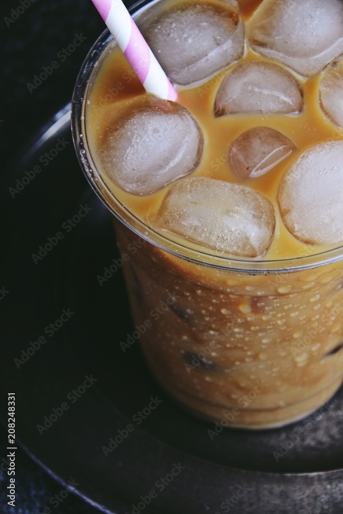 Iced latte to go on the dark backgroind. Iced coffee isolated Iced latte to go on the dark backgroind. Iced coffee isolated