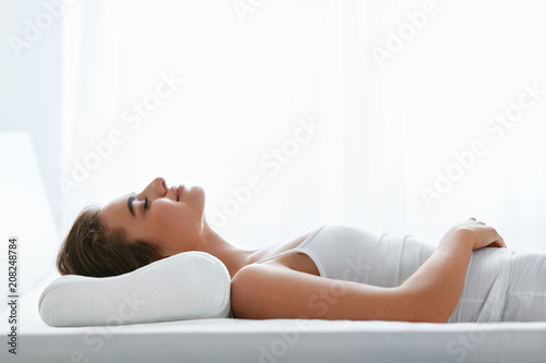 Orthopedic Pillow. Woman Lying In Bed photo