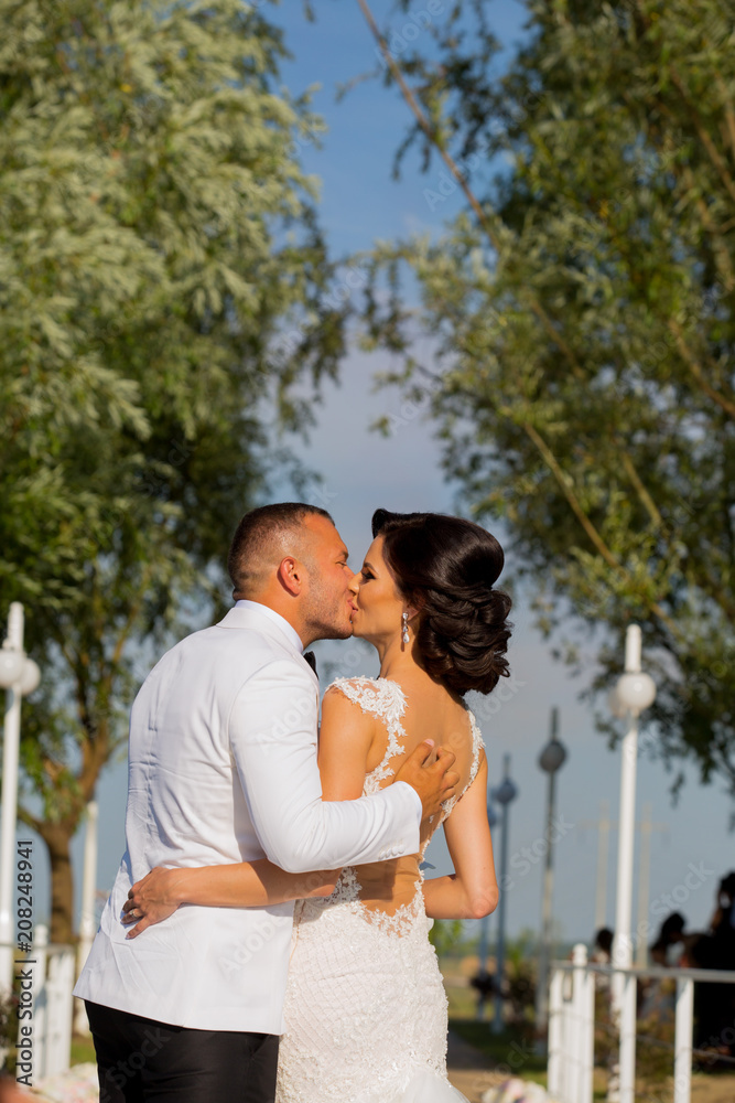 Romanic wedding couple posing in park Romanic wedding couple posing in park