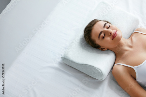 Orthopedic Pillow. Woman Lying In Bed photo