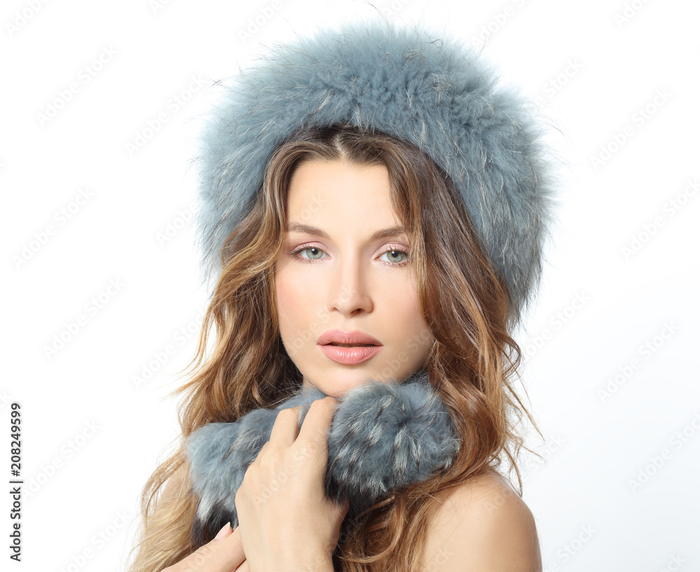 PORTRAIT OF A WOMAN WITH WAVY HAIR BLUE EYES AND FUR HAT