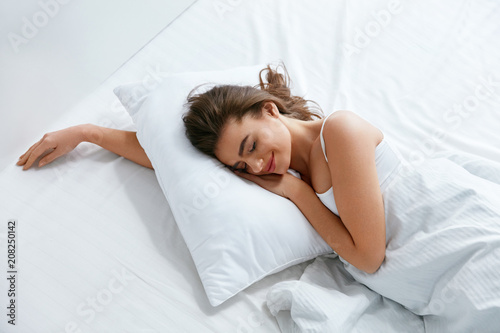 Pillows. Woman Resting On White Pillow Sleeping In Bed photo