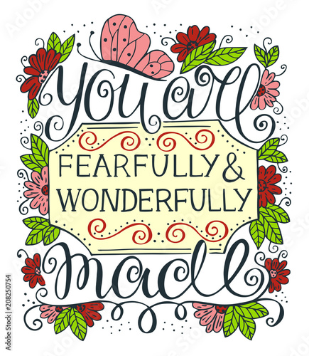 Hand lettering with motivational quote You are fearfully and wonderfully made near color flowers, leaves and butterfly .