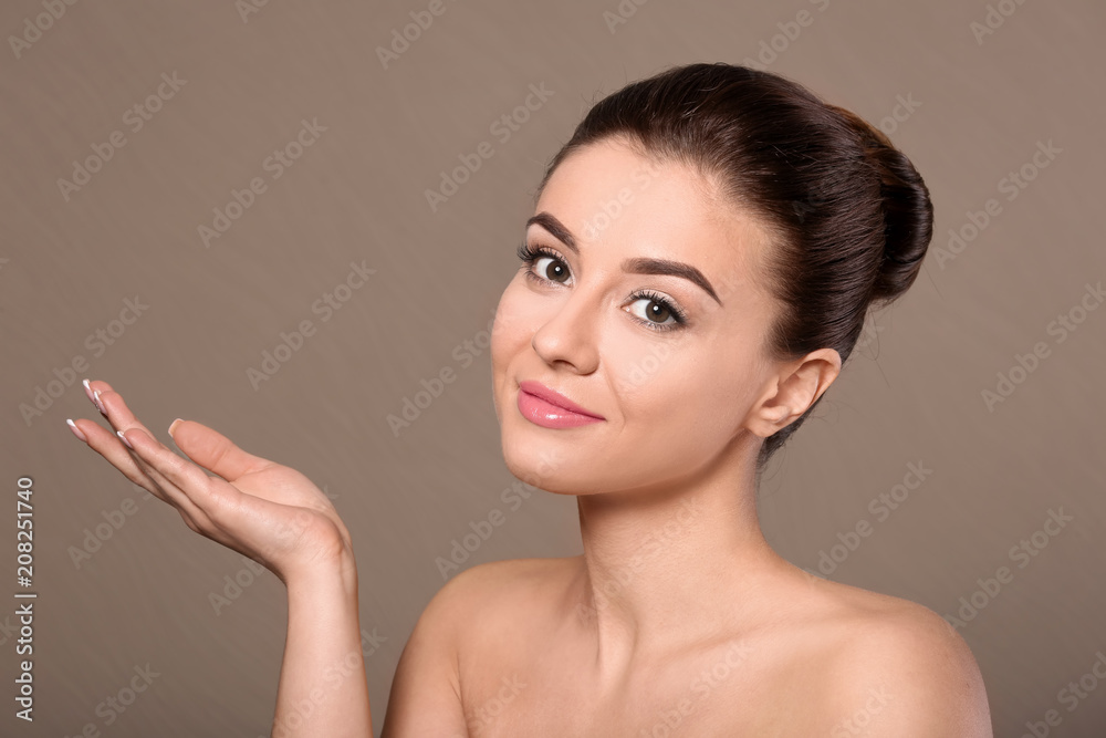Beautiful young woman with silky skin after spa treatment on color background Beautiful young woman with silky skin after spa treatment on color background