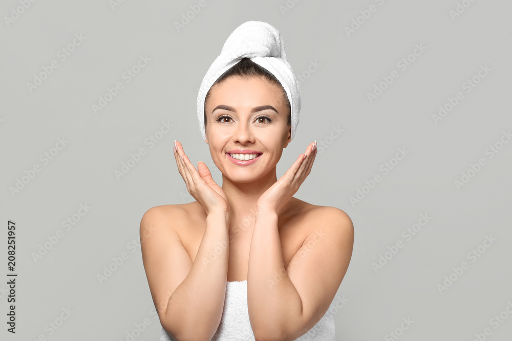 Beautiful young woman with silky skin after spa treatment on light background Beautiful young woman with silky skin after spa treatment on light background