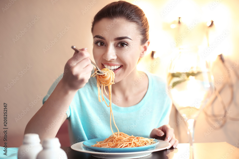 Young woman eating tasty pasta in cafe Young woman eating tasty pasta in cafe