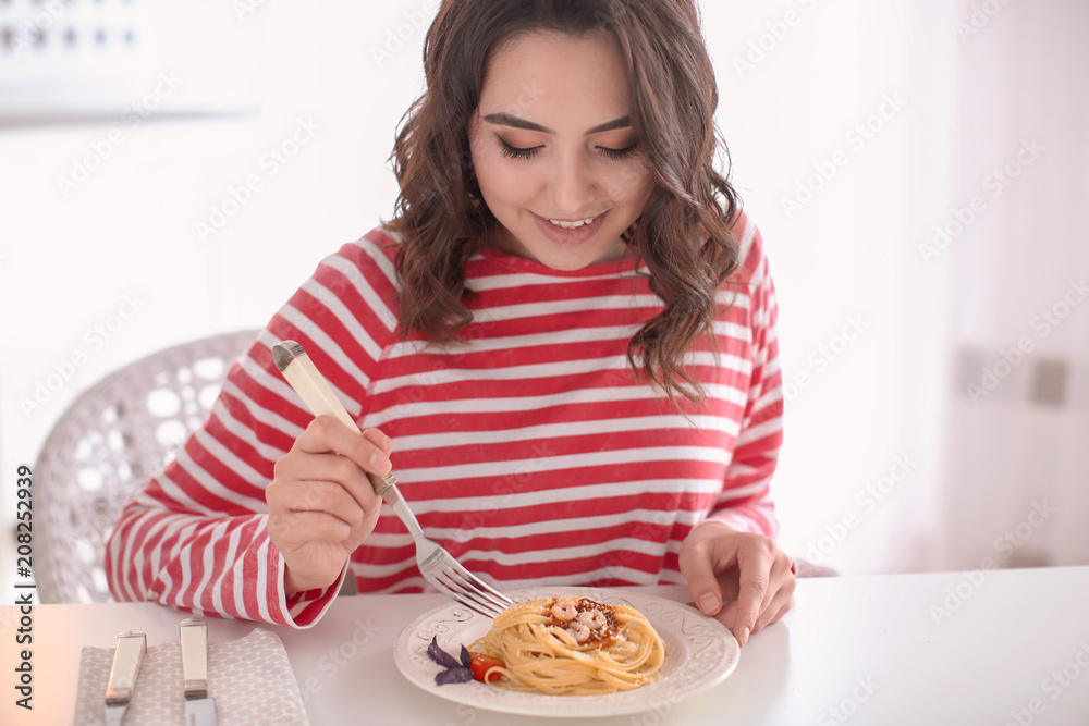 Young woman eating tasty pasta at table Young woman eating tasty pasta at table