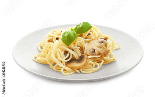 Plate of delicious pasta with mushrooms on white background