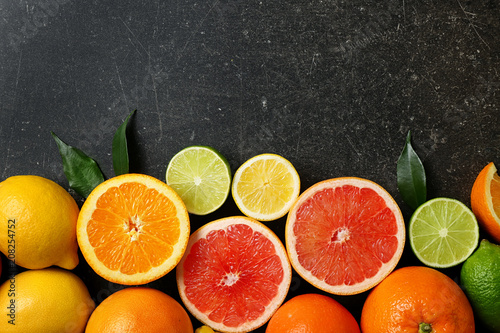 Ripe citrus fruits on gray background © Pixel-Shot