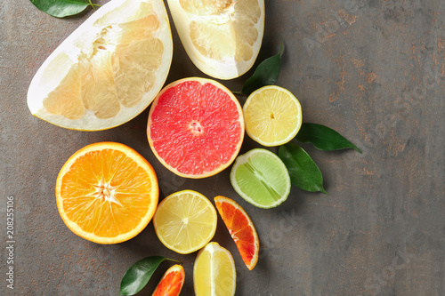Fototapeta Naklejka Na Ścianę i Meble -  Sliced citrus fruits on grey background