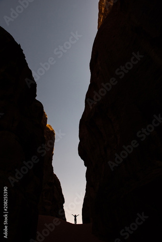 Amazing scale, silhouette of woman in a canyon