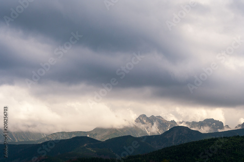 Dark gray and blue clouds above the mountains