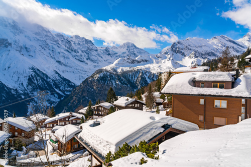 View of the house covered with snow at Murren Village with the snow mountain in the background