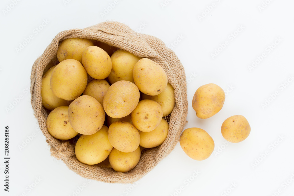 Sack of fresh raw potatoes on wooden background, top view Sack of fresh raw potatoes on wooden background, top view