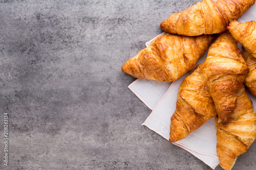 Картината върху платно Tasty buttery croissants on old graye table.