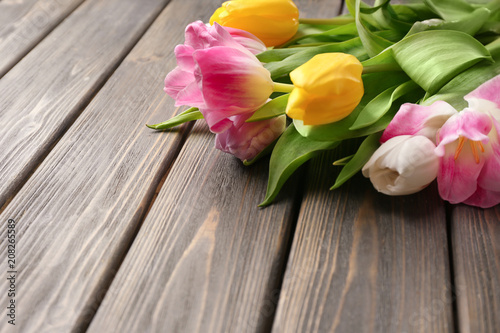 Beautiful colorful tulips on wooden background