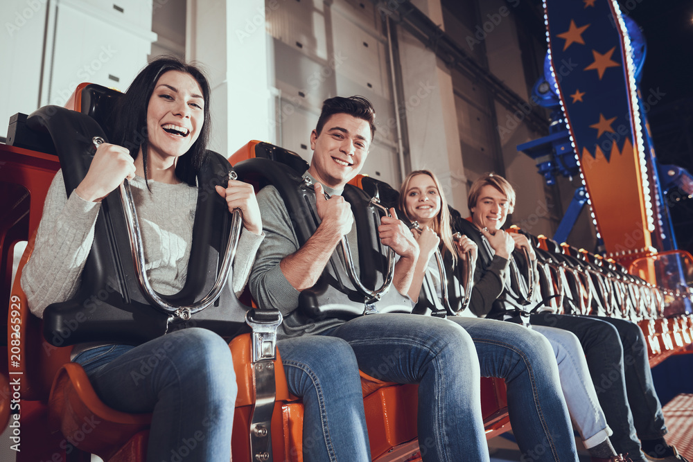 Smiling friends are delighted with amusement park. Smiling friends are delighted with amusement park.