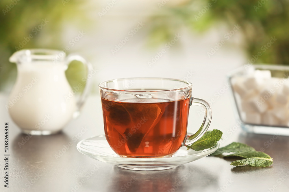 Glass cup of tasty hot tea on table Glass cup of tasty hot tea on table