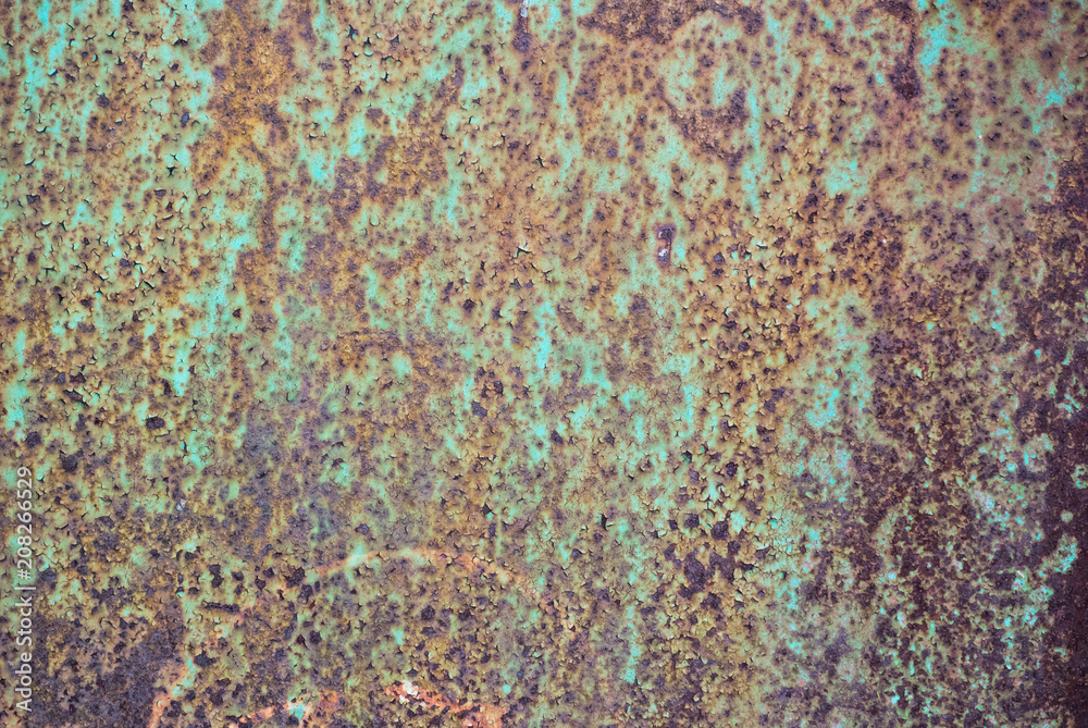Photo of a rusty metal previously painted with green paint