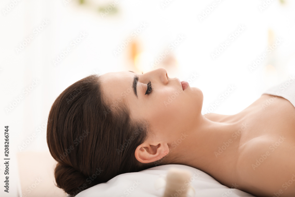 Young woman relaxing in spa salon