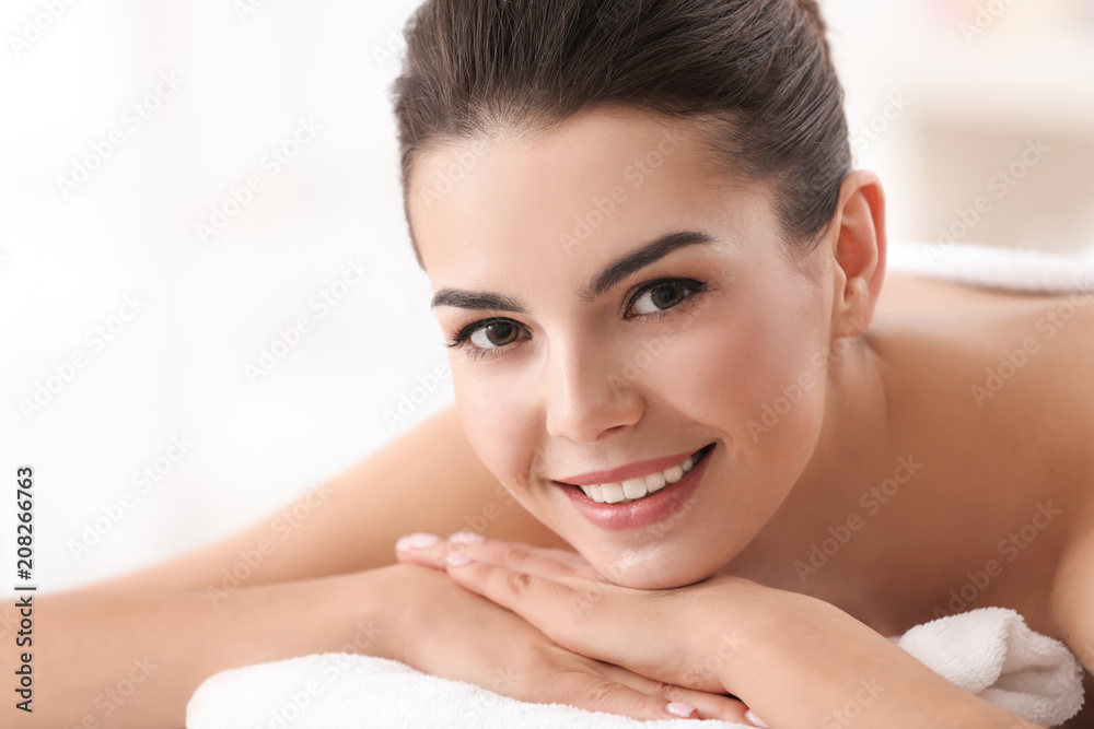 Young woman relaxing in spa salon