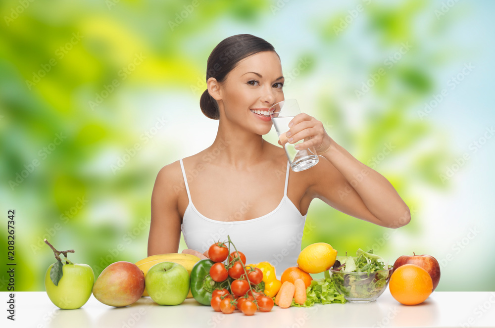 diet, healthy eating and people concept - woman with food on table drinking water over green natural background diet, healthy eating and people concept - woman with food on table drinking water over green natural background