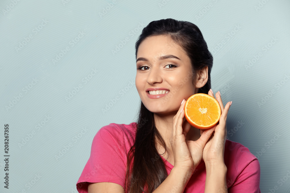 Beautiful young woman with citrus fruit on color background Beautiful young woman with citrus fruit on color background