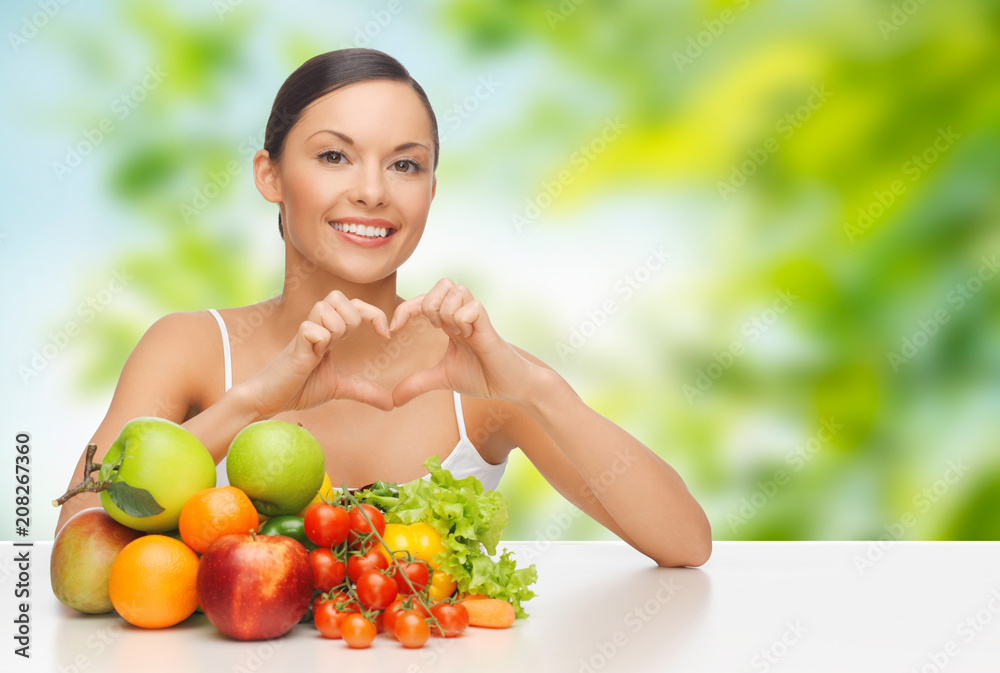 diet, healthy eating and people concept - woman with vegetable food showing hand heart gesture over green natural background diet, healthy eating and people concept - woman with vegetable food showing hand heart gesture over green natural background