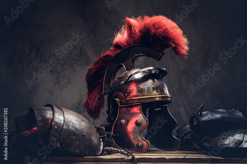 фотографія Complete combat equipment of the ancient Greek warrior lie on a box of wooden boards