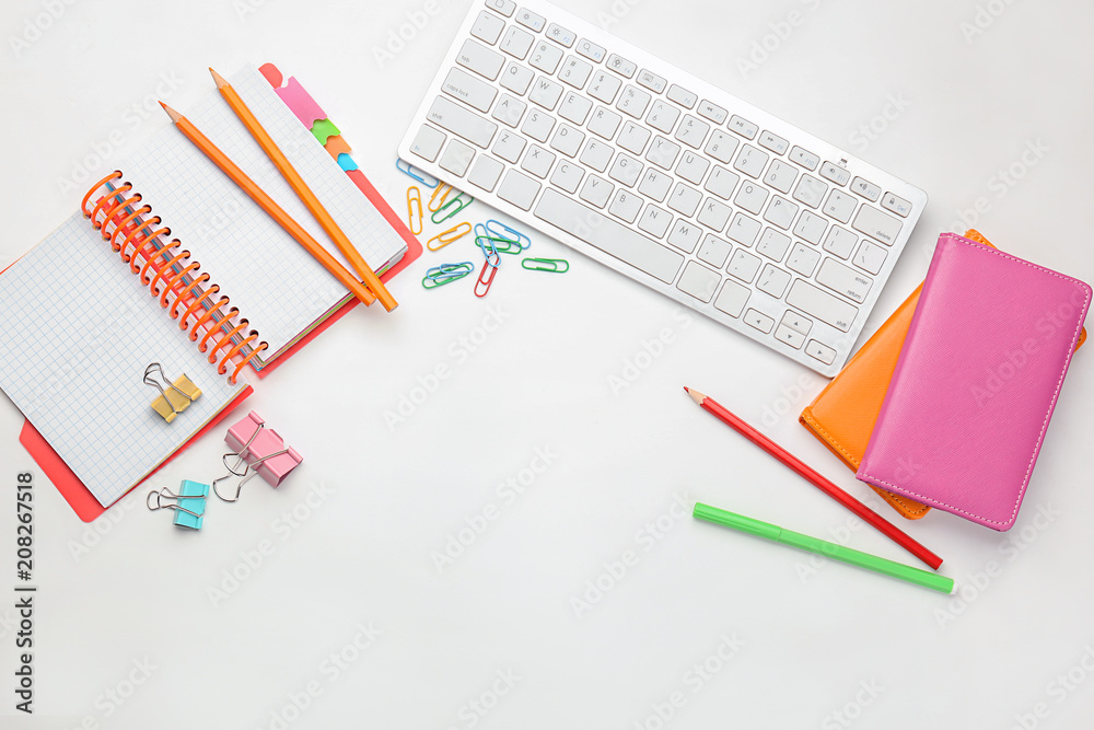 Computer keyboard and stationery on white background, flat lay. Workplace table composition Computer keyboard and stationery on white background, flat lay. Workplace table composition